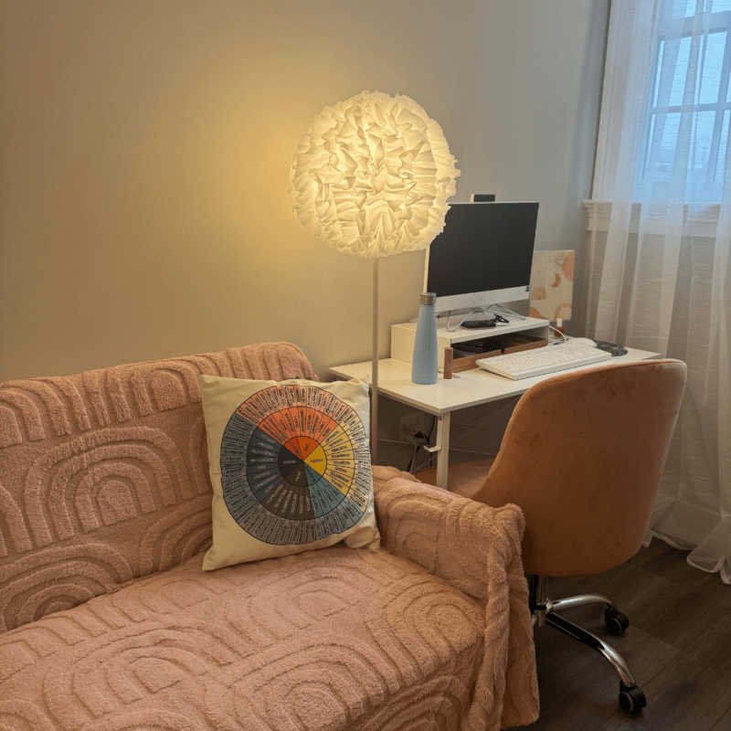 Couch with pillow and desk in Cynthia’s Confidence Coaching & Counseling office