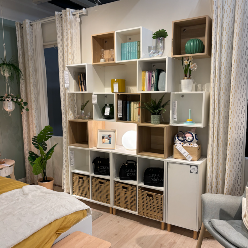 Bedroom with shelving against the wall and multiple plants