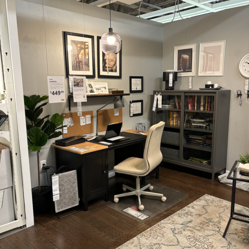 Staged office in IKEA Elizabeth with desk, desk chair, hanging lamp, and bookshelf