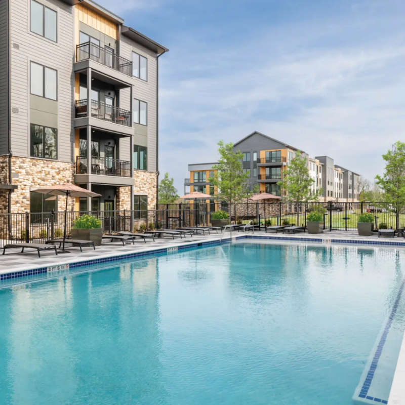 View of Stonehill pool surrounded by trees and Stonehill residential buildings