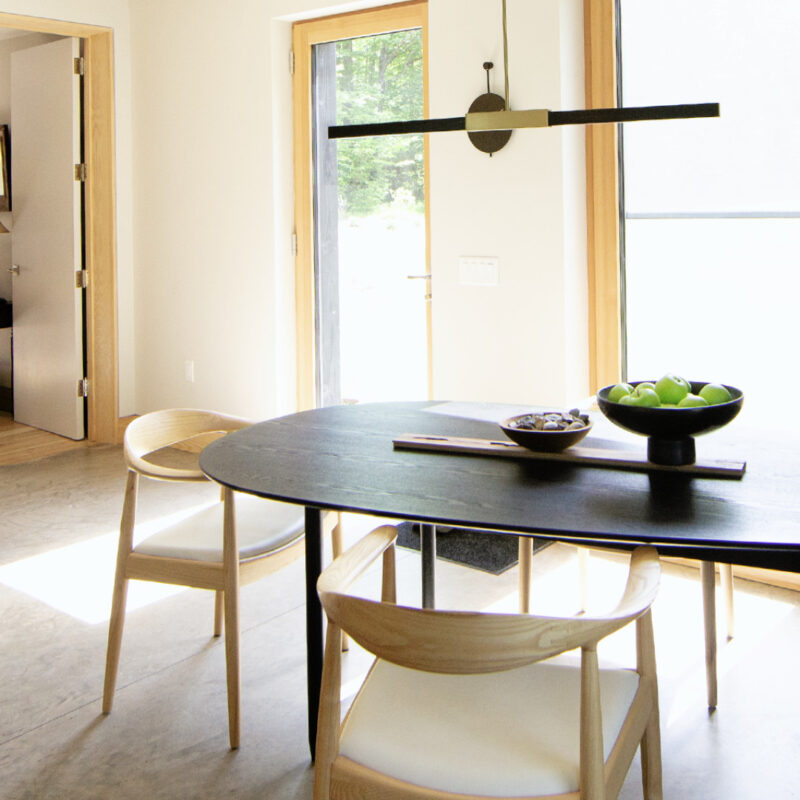 Dining room in The Catskill Project home with dining table, chairs, and large windows letting in natural light