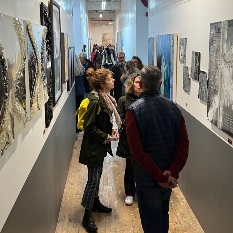 People looking at gallery walls of art