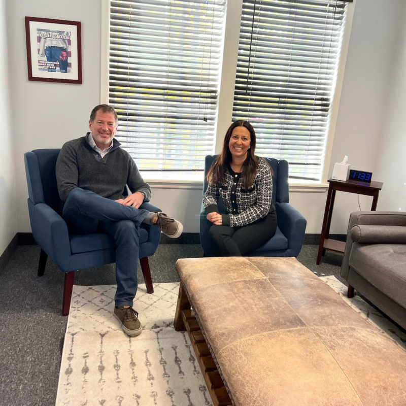 Dr. Ron Wasser and Dr. Keri Wasser sitting in blue chairs
